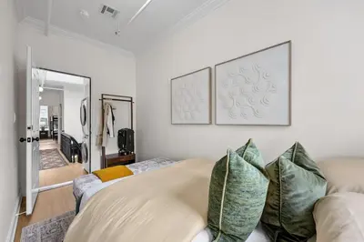 a living room with white walls and a couch at 3BR Brownstone near Subway & Columbia Uni in New York