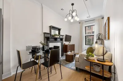 a living room with a table and a dining room at 3BR Brownstone near Subway & Columbia Uni in New York