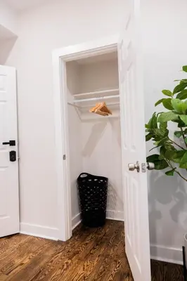 a closet with a white door and a plant at Joynest Place in Newark