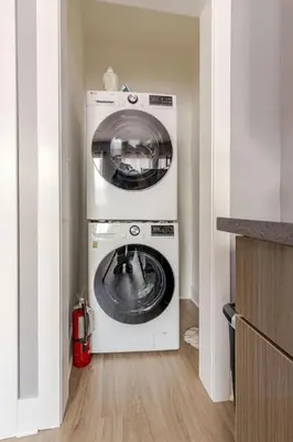 a washer and dryer in the corner of a kitchen at Modern 2 Bedroom in Black Rock in Bridgeport