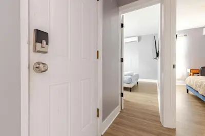 a white door leading to a bedroom with a bed at Modern 2 Bedroom in Black Rock in Bridgeport