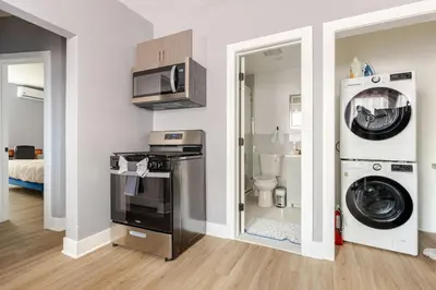 a kitchen with a washing machine and a washer at Modern 2 Bedroom in Black Rock in Bridgeport