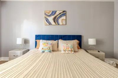 a bedroom with a bed with a blue head board at Modern 2 Bedroom in Black Rock in Bridgeport