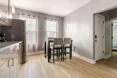 a kitchen with a table and chairs in a room at Modern 2 Bedroom in Black Rock in Bridgeport