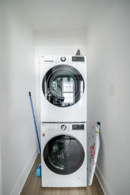 a washer and dryer in a corner of a room at 3 Bedrm Apt at Black Rock Suites in Bridgeport