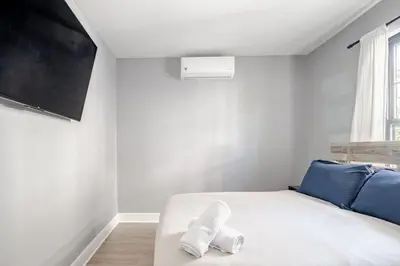 a bedroom with a white bed and a window at 3 Bedrm Apt at Black Rock Suites in Bridgeport