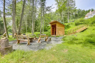 a wooden cabin with benches in a field at 13 Mi to Ski Big Bear Updated Getaway with Deck in Shohola