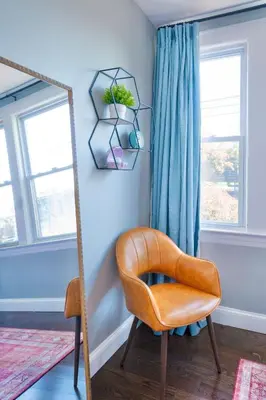a mirror and a chair in a room at The Hillside | Full House | Parking | Near EWR-NYC in Newark