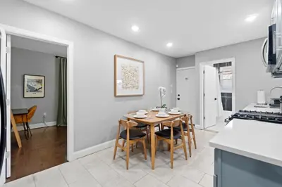 a kitchen and dining room with a table and chairs at Urban Charm | Near EWR Airport Easy Access to NYC in Newark