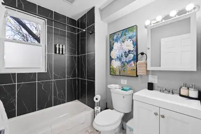 a bathroom with a white toilet and a sink at Urban Charm | Near EWR Airport Easy Access to NYC in Newark