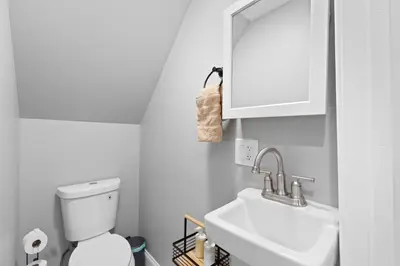 a white bathroom with a toilet and a sink at Urban Charm | Near EWR Airport Easy Access to NYC in Newark