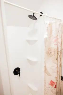a white shower curtain hanging from a curtain rod at Joynest Loft - Private Entry & Bath in Newark