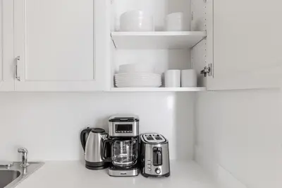 a kitchen counter with a toaster and a coffee maker at Blueground Midtown East doorman nr MoMA NYC-1786 in New York