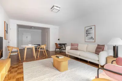 a living room with a white couch and a table at Blueground Midtown East doorman nr MoMA NYC-1786 in New York