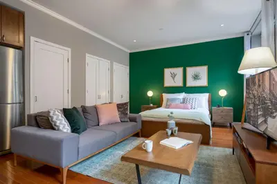 a living room with a couch and a bed at Midtown Studio w Doorman Gym nr MSG NYC-143 in New York
