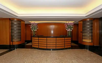 a dressing room with wood paneling and two vases with flowers at Blueground Battery Park City rooftop nr Hudson River NYC-586 in New York