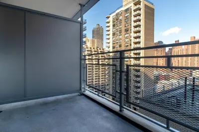 a balcony with a view of the city at Blueground Yorkville pool nr Central Park NYC-1329 in New York
