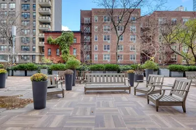 a group of benches in a courtyard with buildings at Blueground Yorkville pool nr Central Park NYC-1329 in New York