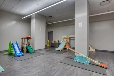 a gym with several play equipment in a room at Blueground Yorkville pool nr Central Park NYC-1329 in New York
