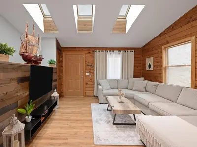 a living room with a couch and a tv at 5 min to Lake Chic Cozy Hot Tub in Sparta