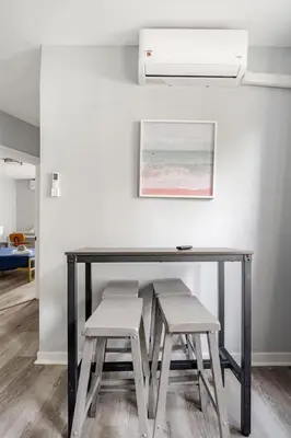 a desk with two stools and a table with a picture at Modern 2 Bed in BlackRock in Bridgeport