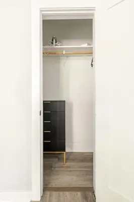 a room with white walls and a black cabinet at Modern 2 Bed in BlackRock in Bridgeport