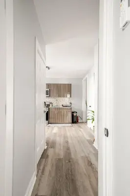 an empty living room with white walls and wood floors at Modern 2 Bed in BlackRock in Bridgeport