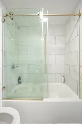 a bathroom with a shower with a tub and a toilet at Modern 2 Bed in BlackRock in Bridgeport