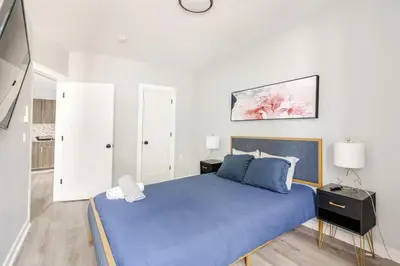 a bedroom with a blue bed and white walls at Modern 2 Bed in BlackRock in Bridgeport