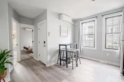 a living room with a table and stools at Modern 2 Bed in BlackRock in Bridgeport