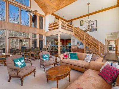 a living room with a couch and a table at Fireplaces, Home Theater, Ski-In Out Windham Lodge in Windham