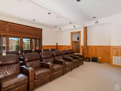 a large room with brown leather chairs and a screen at Fireplaces, Home Theater, Ski-In Out Windham Lodge in Windham