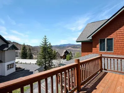 a deck with a view of a house at Fireplaces, Home Theater, Ski-In Out Windham Lodge in Windham