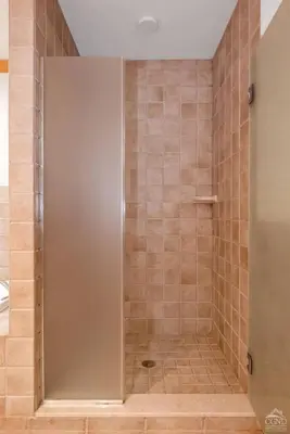 a shower with a glass door in a bathroom at Fireplaces, Home Theater, Ski-In Out Windham Lodge in Windham