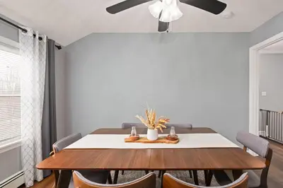 a dining room table with chairs and a ceiling fan at Cozy Home, 17 min from NYC, 2 Parking Spaces in Ridgefield Park