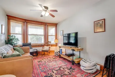 a living room with a couch and a flat screen tv at 6 Mi to Montage Mtn Resort! Family Home with Yard in Scranton