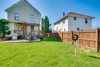a yard with a fence and a hat in the grass at 6 Mi to Montage Mtn Resort! Family Home with Yard in Scranton