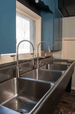 a kitchen with a stainless steel sink and a window at The Pulpit House