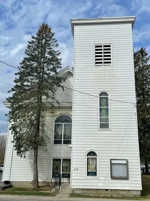 a white house with a tree in front of it at The Pulpit House