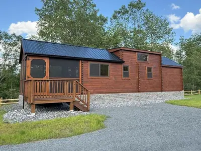 a log cabin with a porch and a deck at Tiny Cabin #2 by Windham NY Escape 'Cozy Stay' in Hensonville