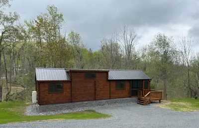 a log cabin with a bench in front of it at Tiny Cabin #2 by Windham NY Escape 'Cozy Stay' in Hensonville