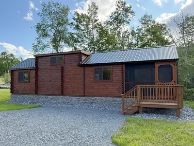 a log cabin with a porch and a deck at Tiny Cabin #5 by Windham NY Escape 'Scenic Stay' in Hensonville