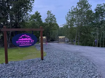 a sign for a wildlife park with a gravel road at Tiny Cabin #5 by Windham NY Escape 'Scenic Stay' in Hensonville