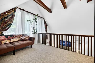 a living room with a couch and a window at Hideout Pocono Chalet in Lake Ariel