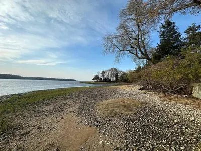 a rocky beach next to a body of water at Waterfront Paradise in St James in Nissequogue