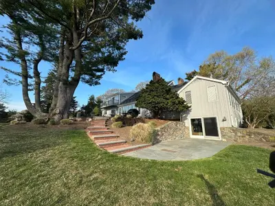 a house with a tree on top of it at Waterfront Paradise in St James in Nissequogue