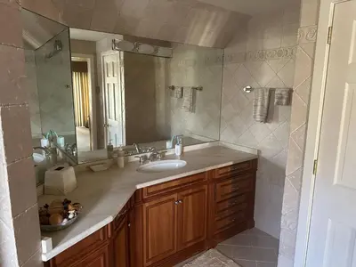 a bathroom with a sink and a mirror at Waterfront Paradise in St James in Nissequogue