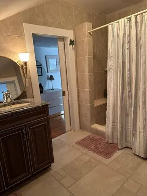 a bathroom with a shower and a sink at Historic Home near Stony Brook Village & Beach in Stony Brook