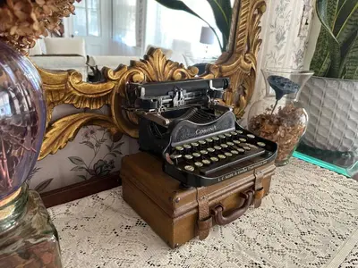 a typewriter sitting on a table in front of a mirror at Historic Home near Stony Brook Village & Beach in Stony Brook