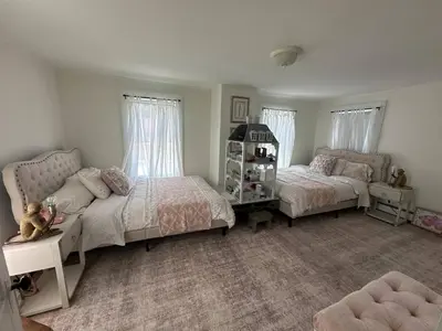 a bedroom with two beds and a couch at Historic Home near Stony Brook Village & Beach in Stony Brook